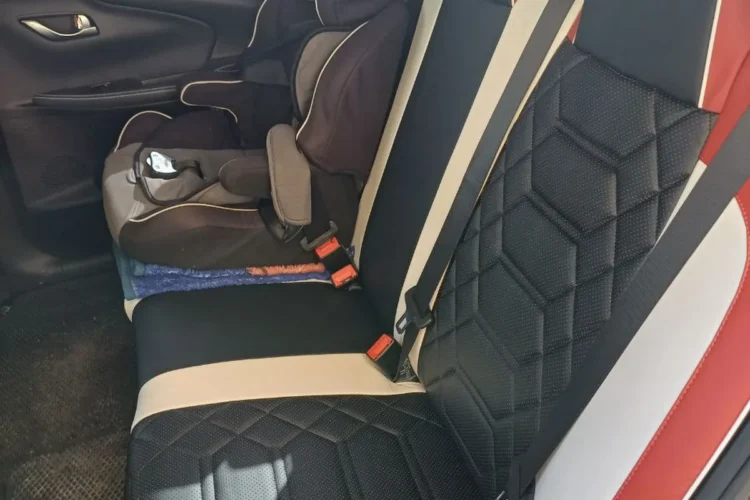 Задний диван Changan Alsvin в кожаных чехлах, на нём детское кресло