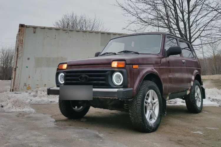 Вишнёвая Нива на литых дисках с зимними шинами 215/65 R16