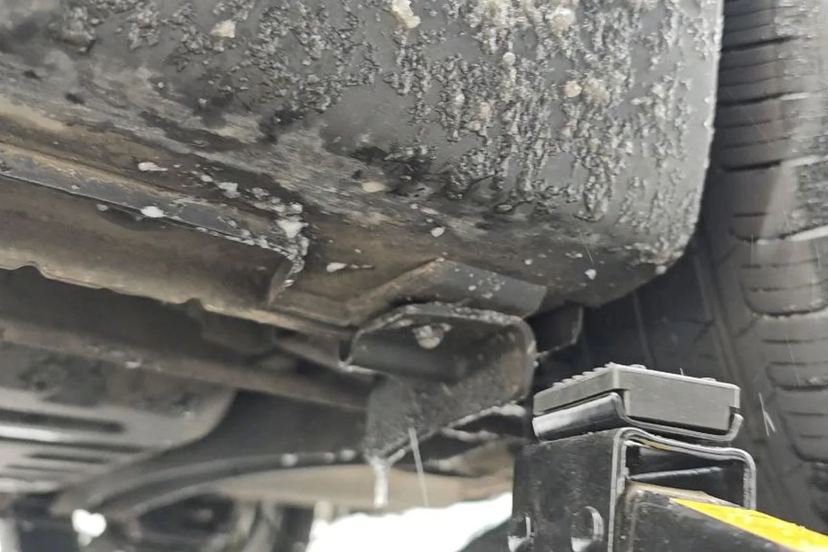 Подкатной домкрат под порогом Kia Rio у штатной точки подъёма