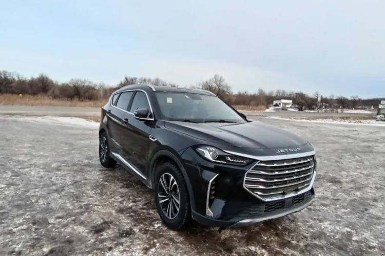 Чёрный Jetour X70 Plus зимой на заснеженной площадке