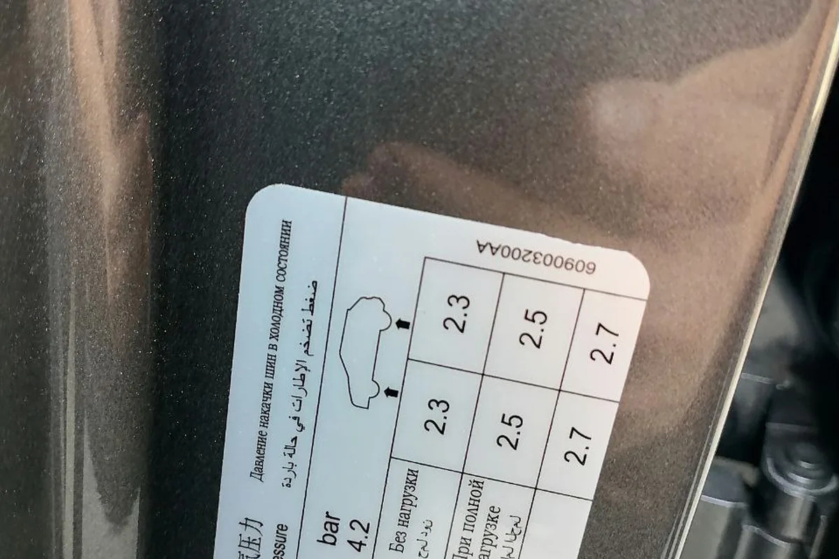 Табличка с рекомендованным давлением в шинах на стойке двери Jetour X70 Plus