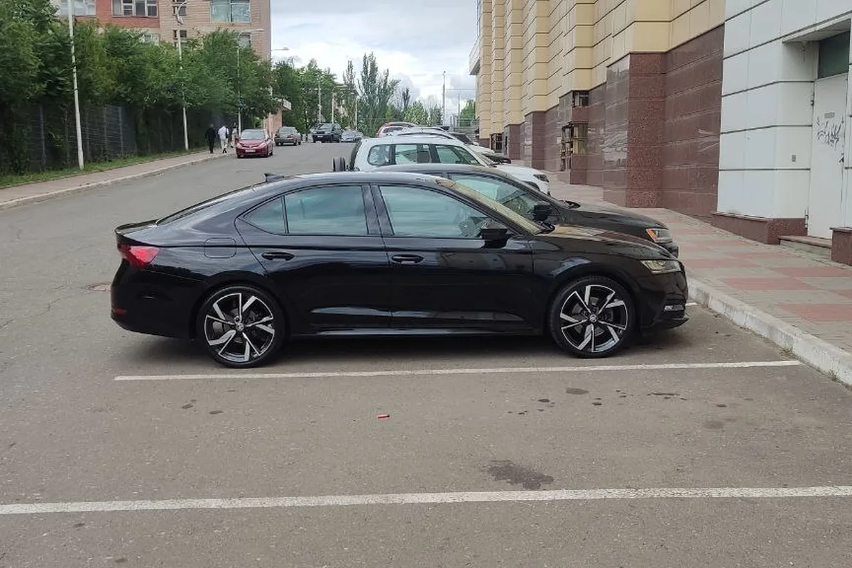 Чёрная Skoda Octavia A8 на парковке, вид сбоку